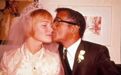 Sammy Davis Jr giving his wife, May-Britt, a kiss on the cheek on their wedding day 