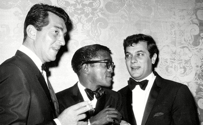Dean Martin, Sammy Davis Jr., and Tony Curtis at a party 