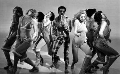 Sammy Davis Jr performing with dancers around him 