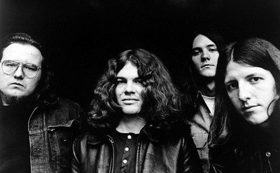 A dated photo of John Hartman, Tom Johnston, Dave Shogren, and Pat Simmons.