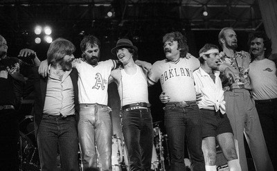 The Doobie Brothers stand on stage at the end of the show.