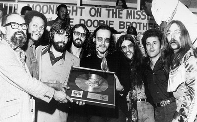 A photo of the Doobie Brothers receiving a gold record.