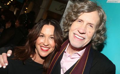 Alanis Morissette and Glen Ballard pose together. 