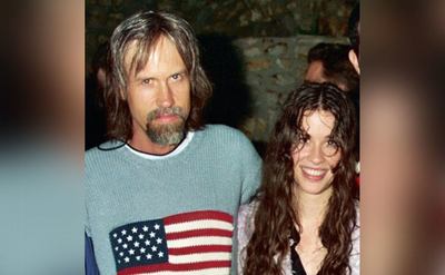 Glen Ballard and Alanis Morissette pose together at a party. 