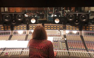 Alanis is working in the recording studio. 