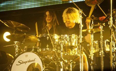 Alanis Morissette performs on stage with drummer Taylor Hawkins. 