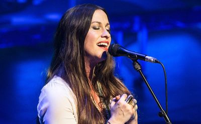Alanis Morissette performs on stage. 